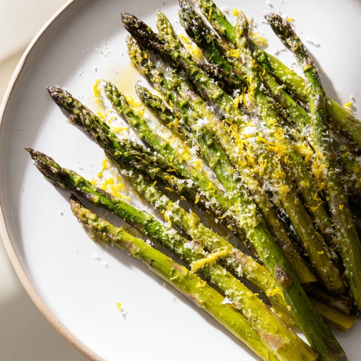Golden-tipped roasted asparagus with Parmesan and Lemon, perfectly tender after a quick roast in the oven.