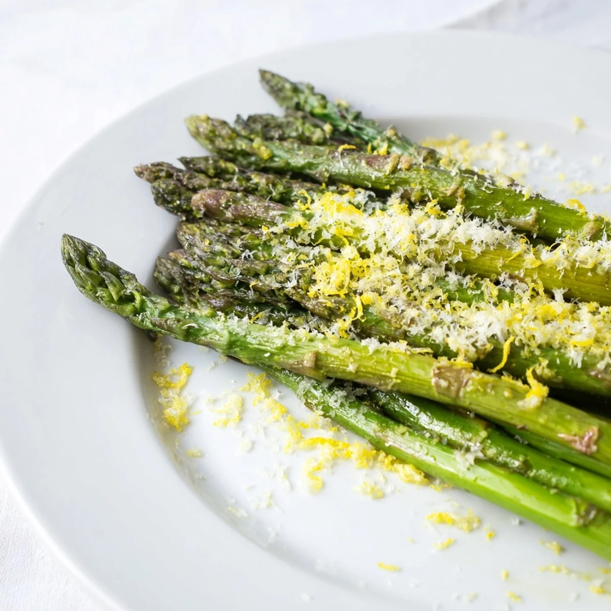 Fresh lemon zest and grated Parmesan atop roasted asparagus, making an easy, elegant side for busy weeknights.