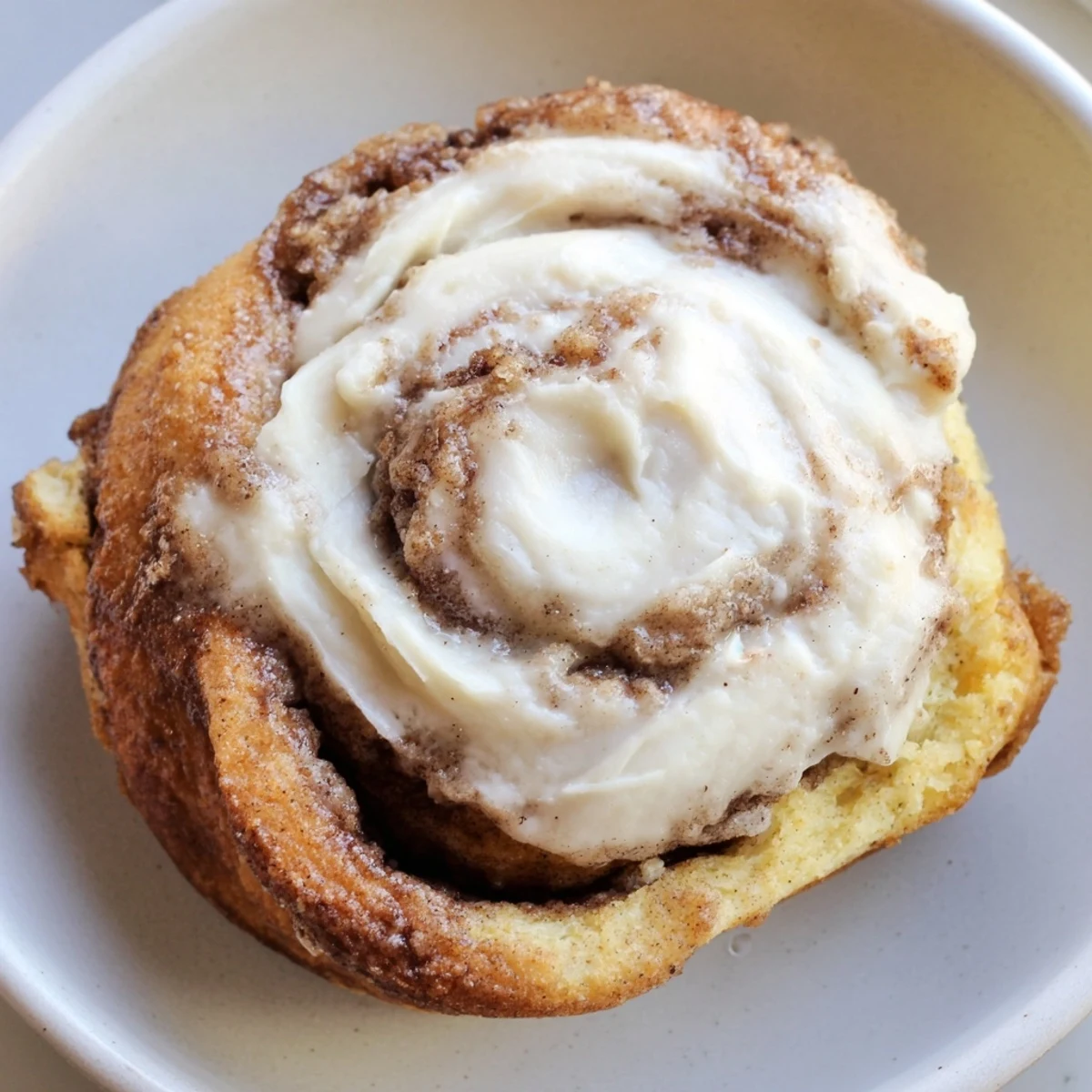 Warm Keto Cinnamon Buns with gooey filling and sugar-free icing drizzle.