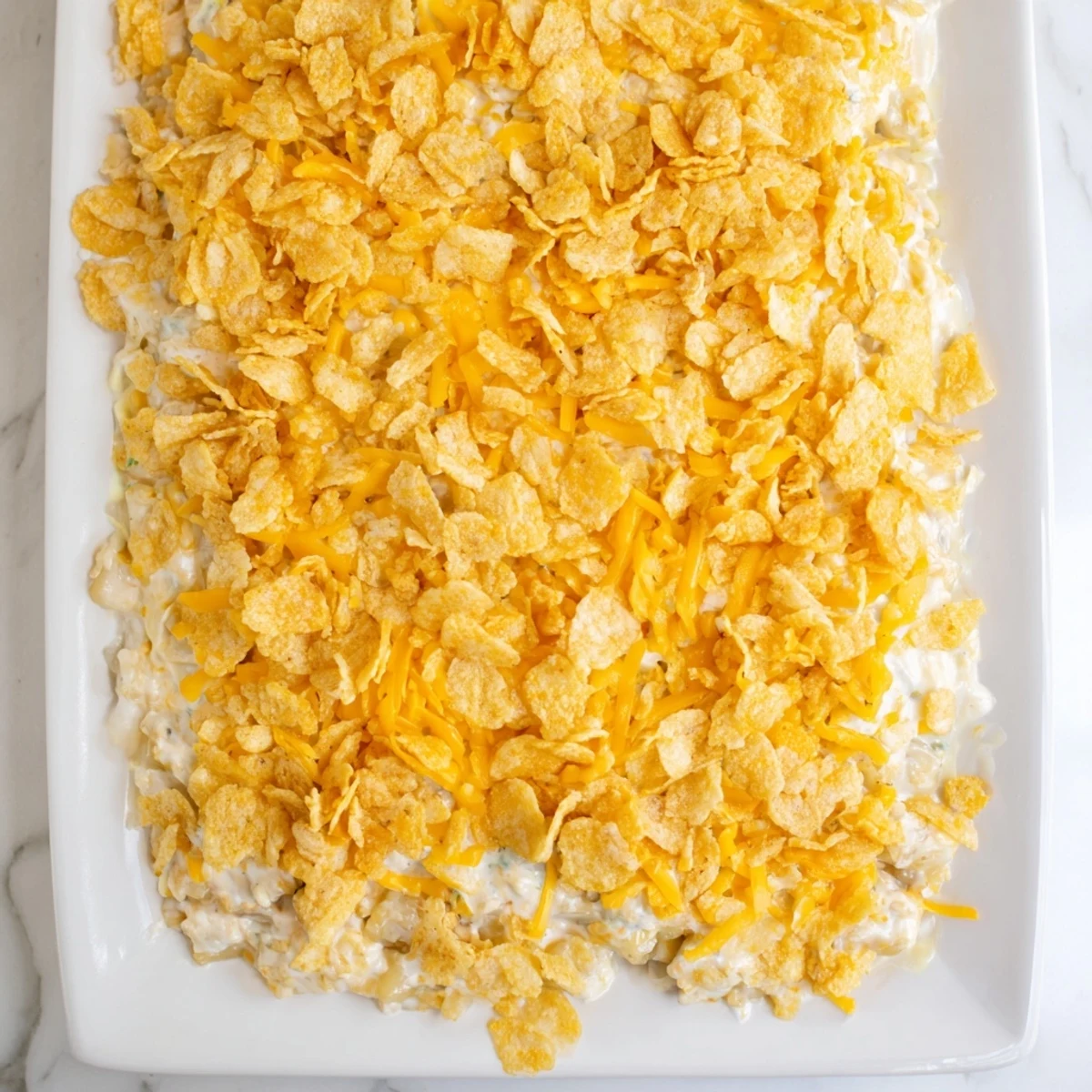 Creamy Funeral Potatoes with Hashbrowns served hot from the oven, topped with melted cheddar and buttery crumbs.