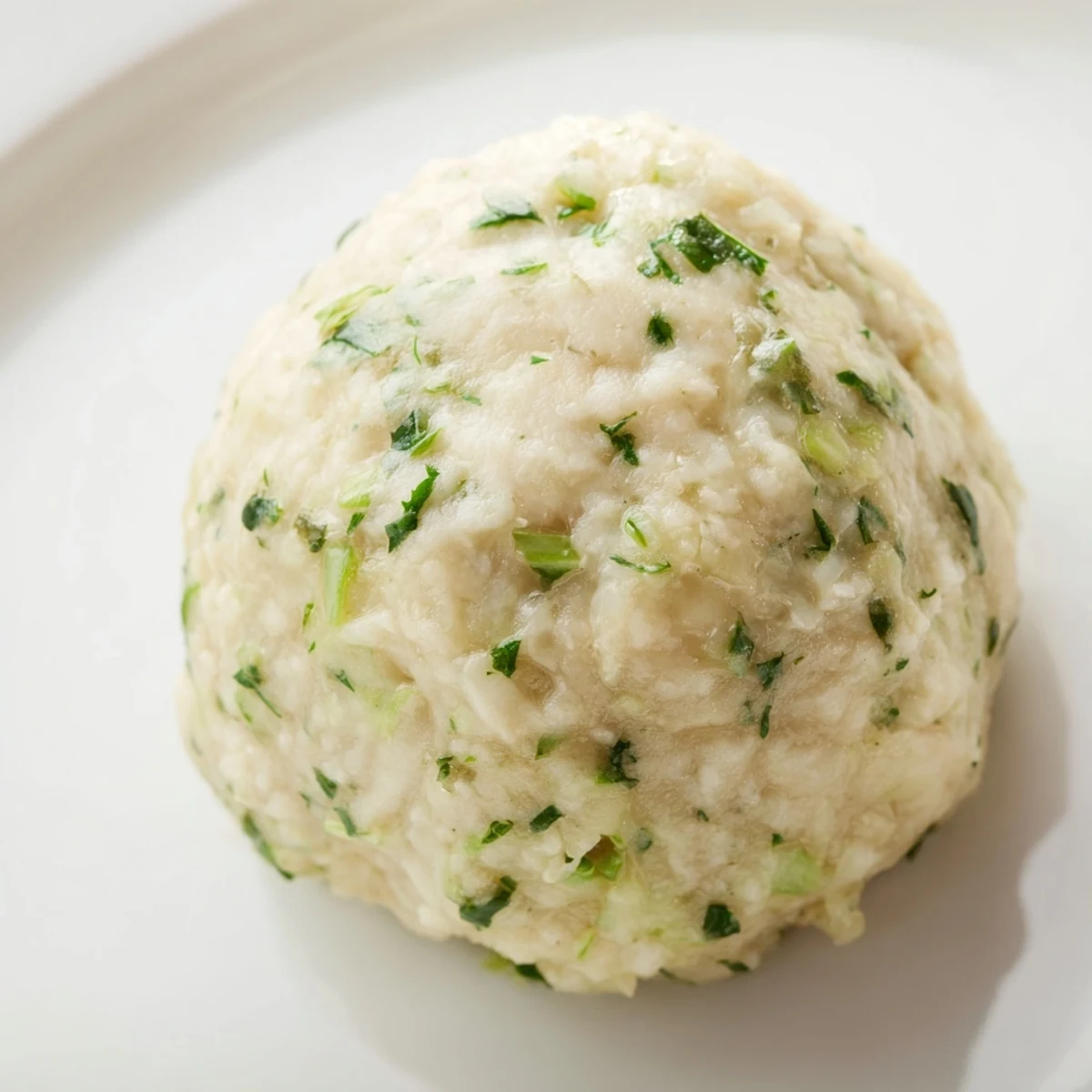 Steaming German Cabbage Dumplings in broth, tender and fluffy, served as a comforting vegetarian main dish.