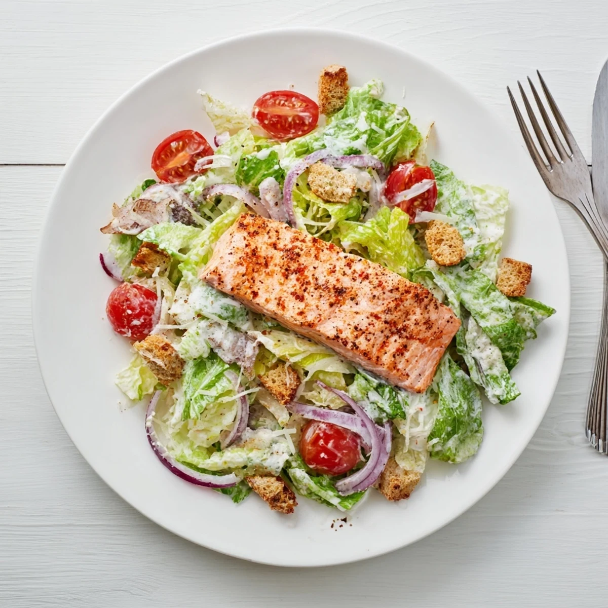 Grilled salmon Caesar salad with crisp romaine, cherry tomatoes, and creamy homemade dressing