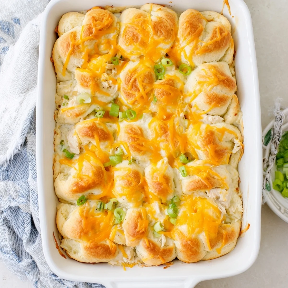 Creamy chicken and cheese filled crescent bake fresh from the oven with melted topping