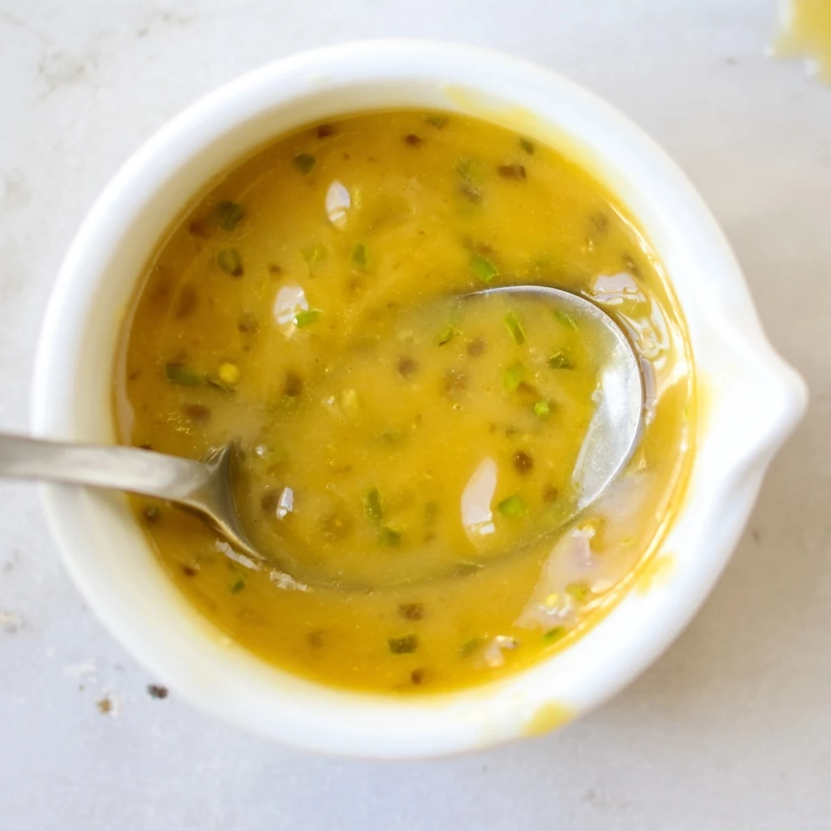Spicy jalapeño honey mustard sauce served as a dipping condiment alongside pretzels and vegetables
