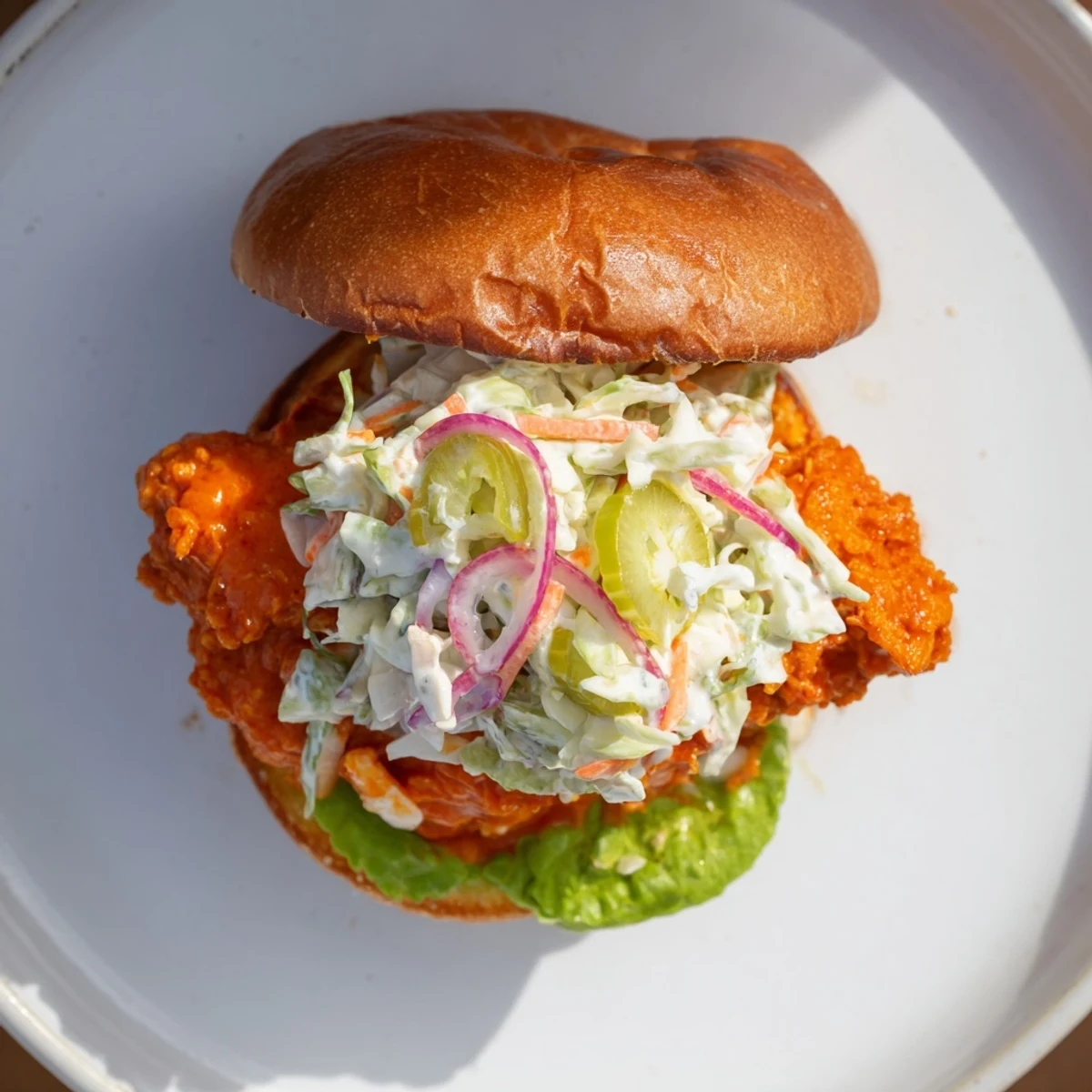 Juicy crispy chicken fillet coated in buffalo sauce with ranch coleslaw on brioche bun