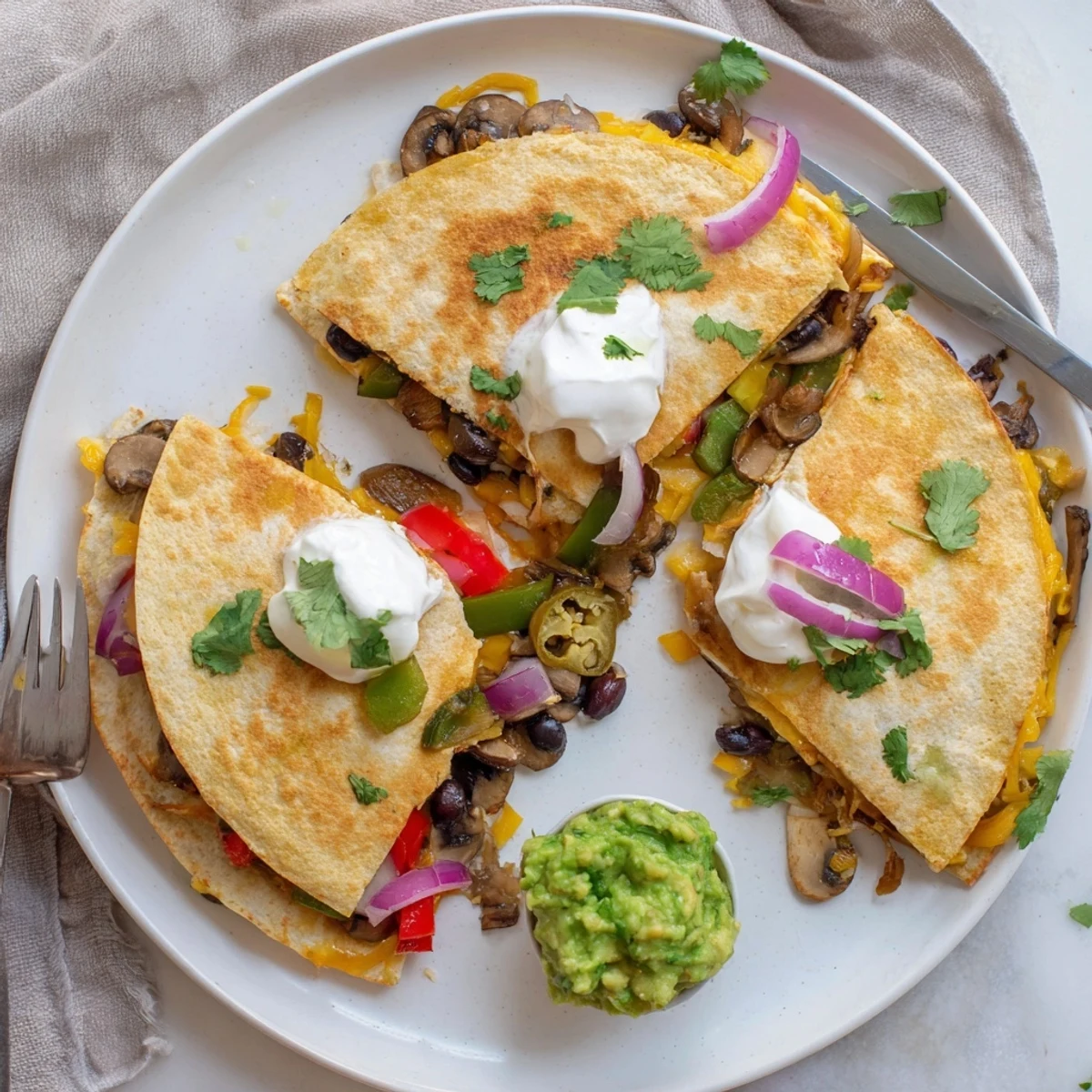 Golden brown quesadillas filled with melted cheddar and Monterey Jack cheese, cut into wedges