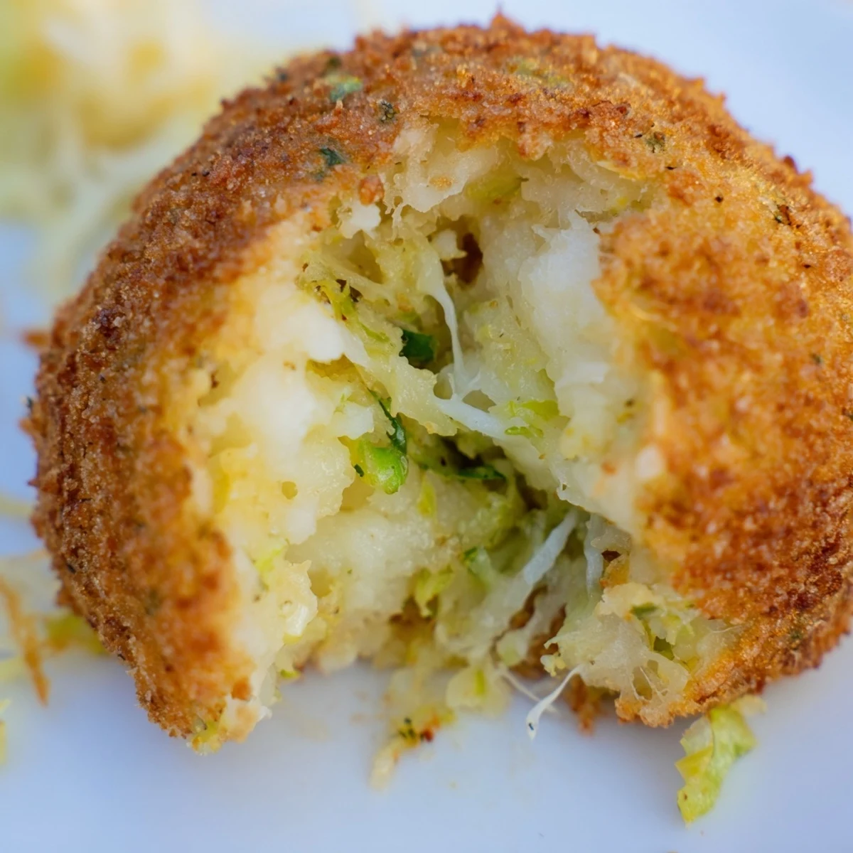 Irish potato and cabbage Cheesy Fried Colcannon Balls with crunchy panko coating and visible cheese pull