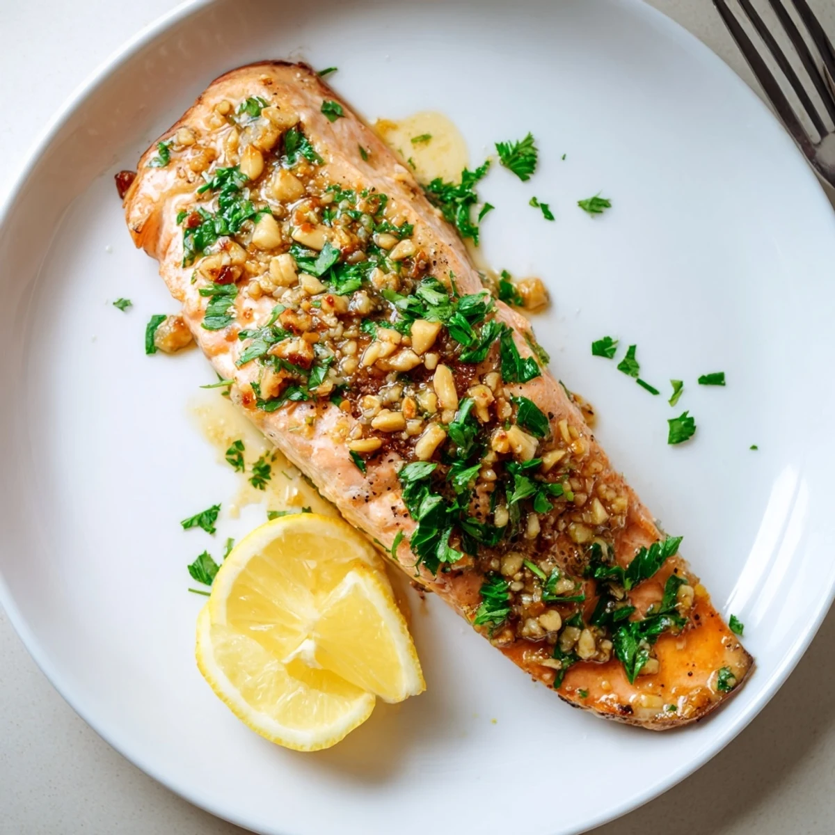 Golden pan-seared honey garlic glazed salmon with thick glossy sauce dripping over the tender fillet