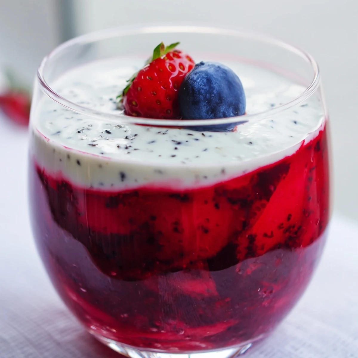 Summer vanilla mousse berry jello dessert showing white custard layer over bright red fruit gelatin