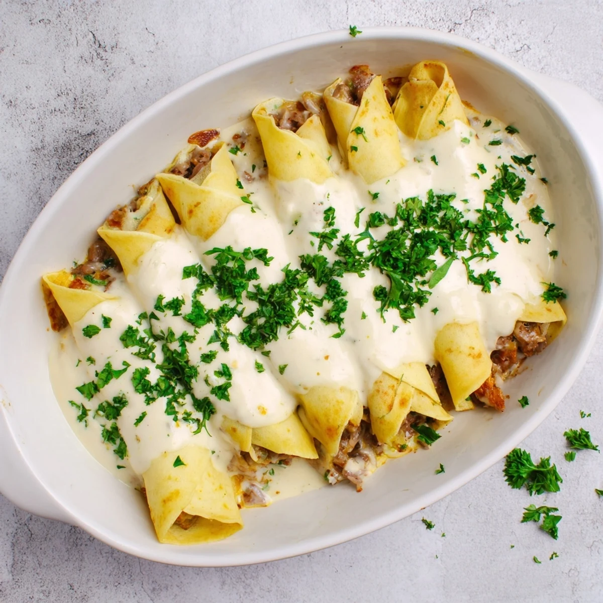 Golden Hortobágyi palacsinta rolls filled with savory paprika meat and topped with bubbly cream sauce