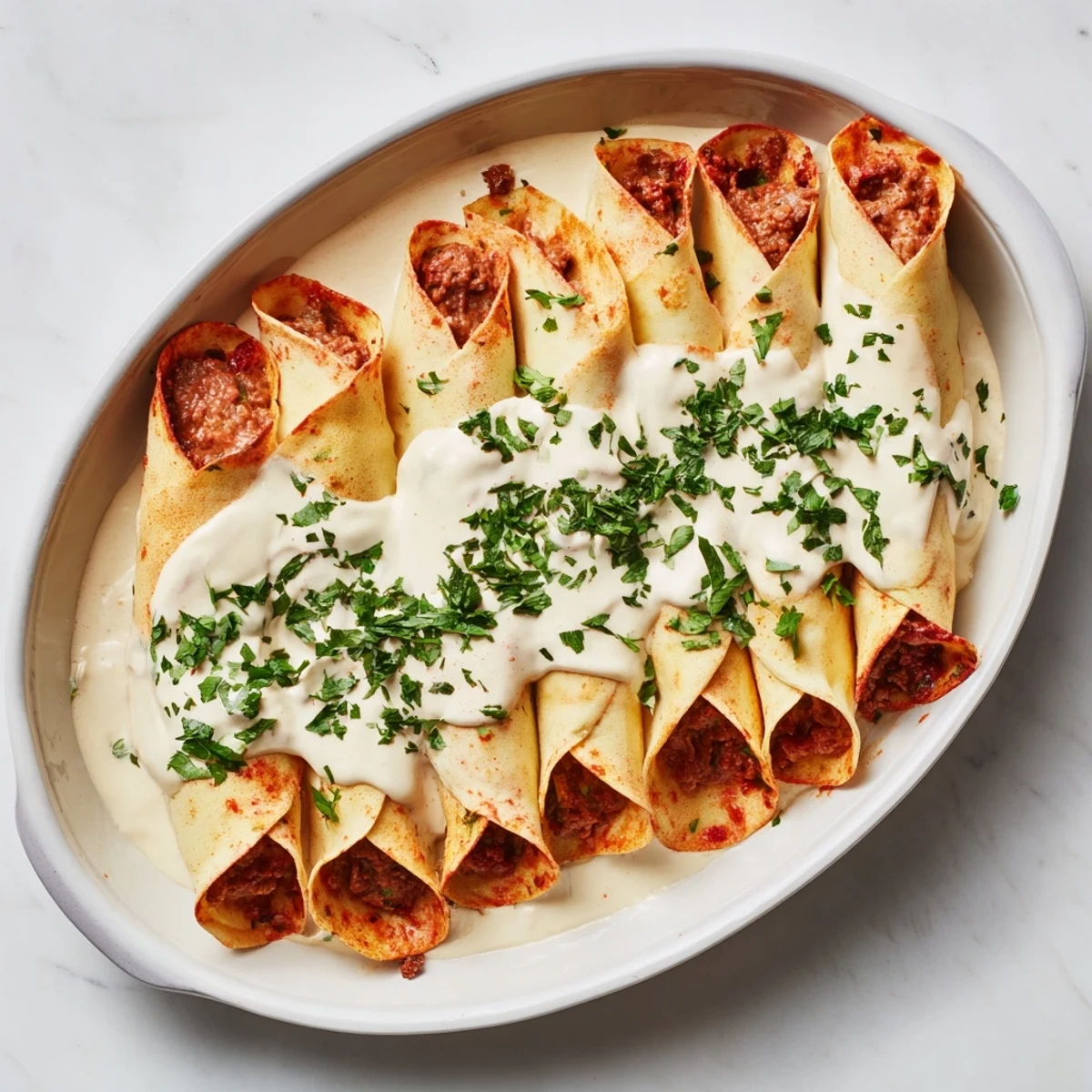 Creamy sour cream glazed Hortobágyi palacsinta showcasing tender meat stuffed crepes fresh from oven
