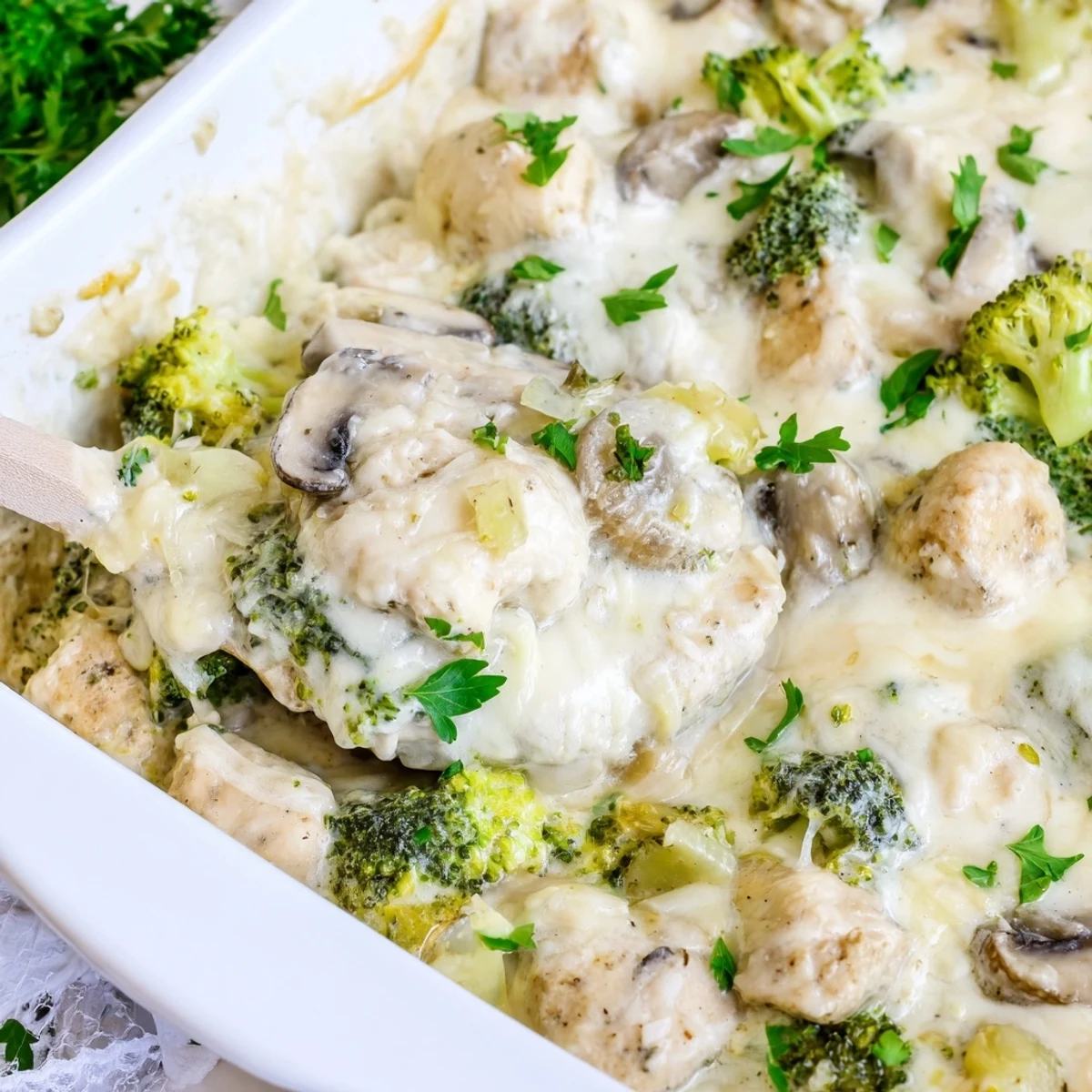 Creamy baked chicken casserole featuring tender broccoli mushrooms in rich cheese sauce