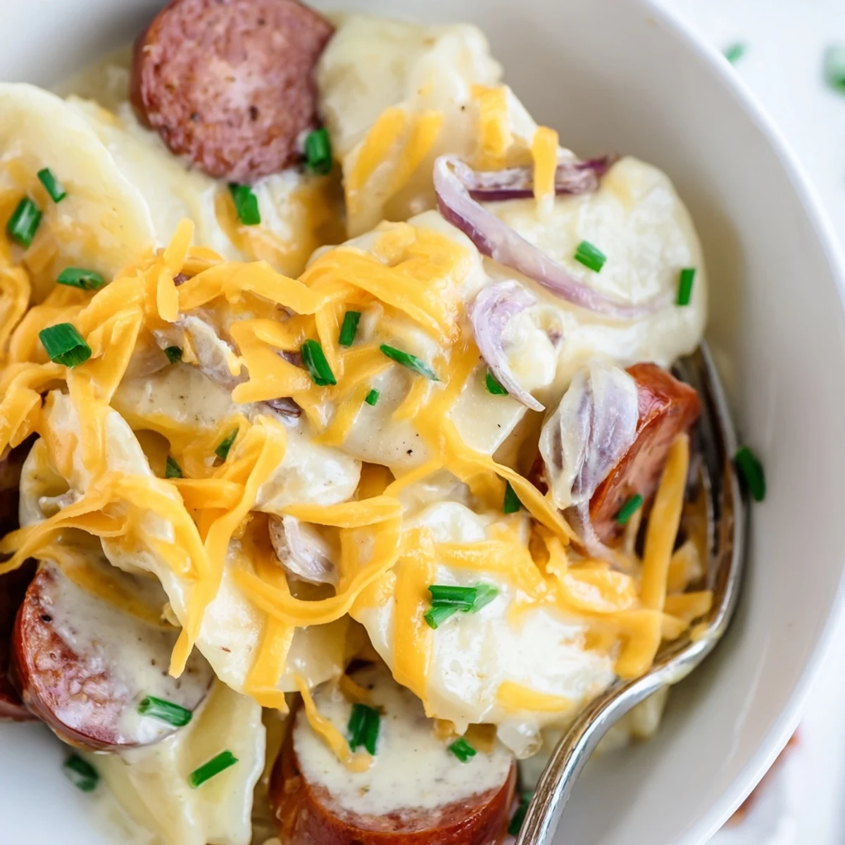 Slow cooker Crock Pot Pierogi Casserole with bubbling cheddar cheese and sliced smoky kielbasa