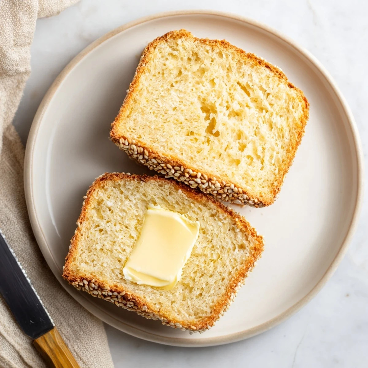 Homemade zero carb yogurt bread slices arranged on plate with golden crust visible