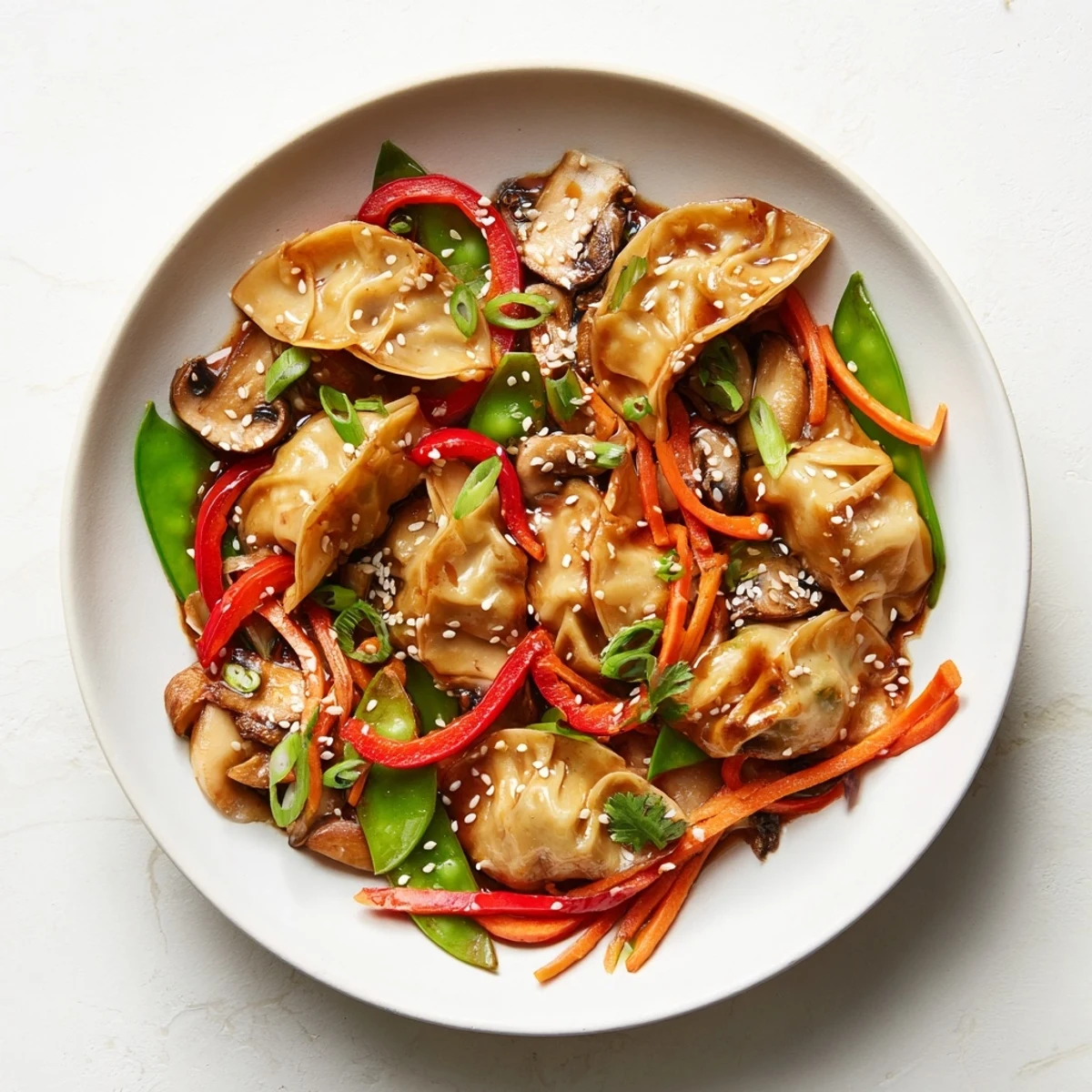 Vibrant potsticker stir fry with fresh snap peas peppers and aromatic sesame ginger glaze