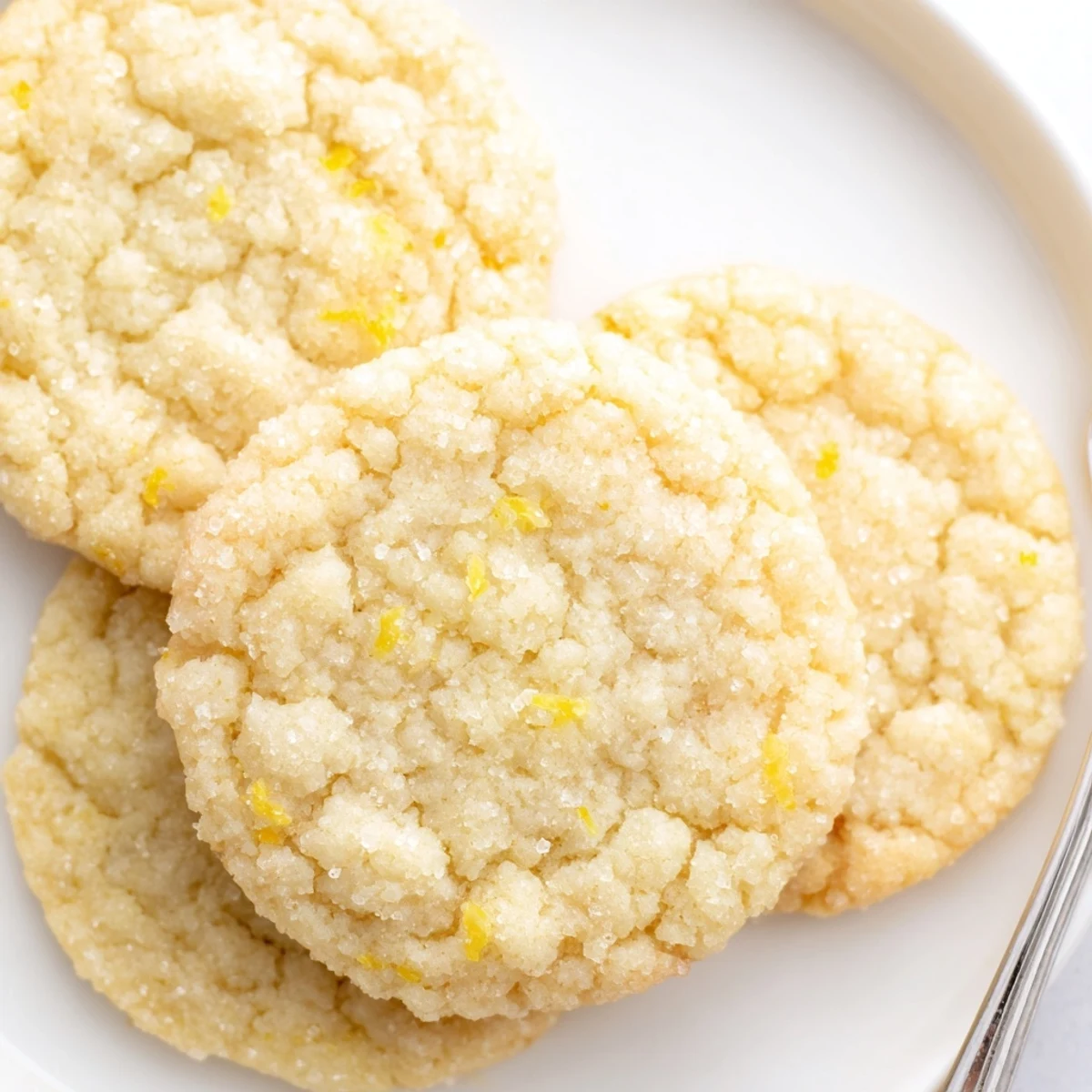 Bright buttery lemon sugar cookies arranged on a white serving platter