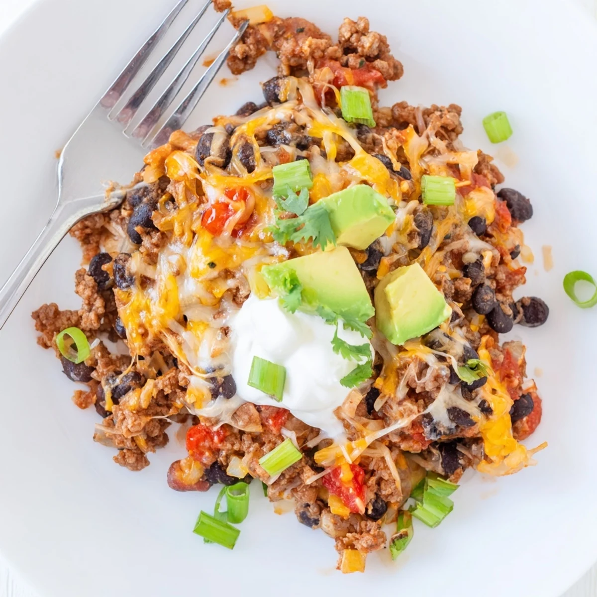 Sizzling Beef Skillet Enchiladas served hot with tortilla quarters and black beans