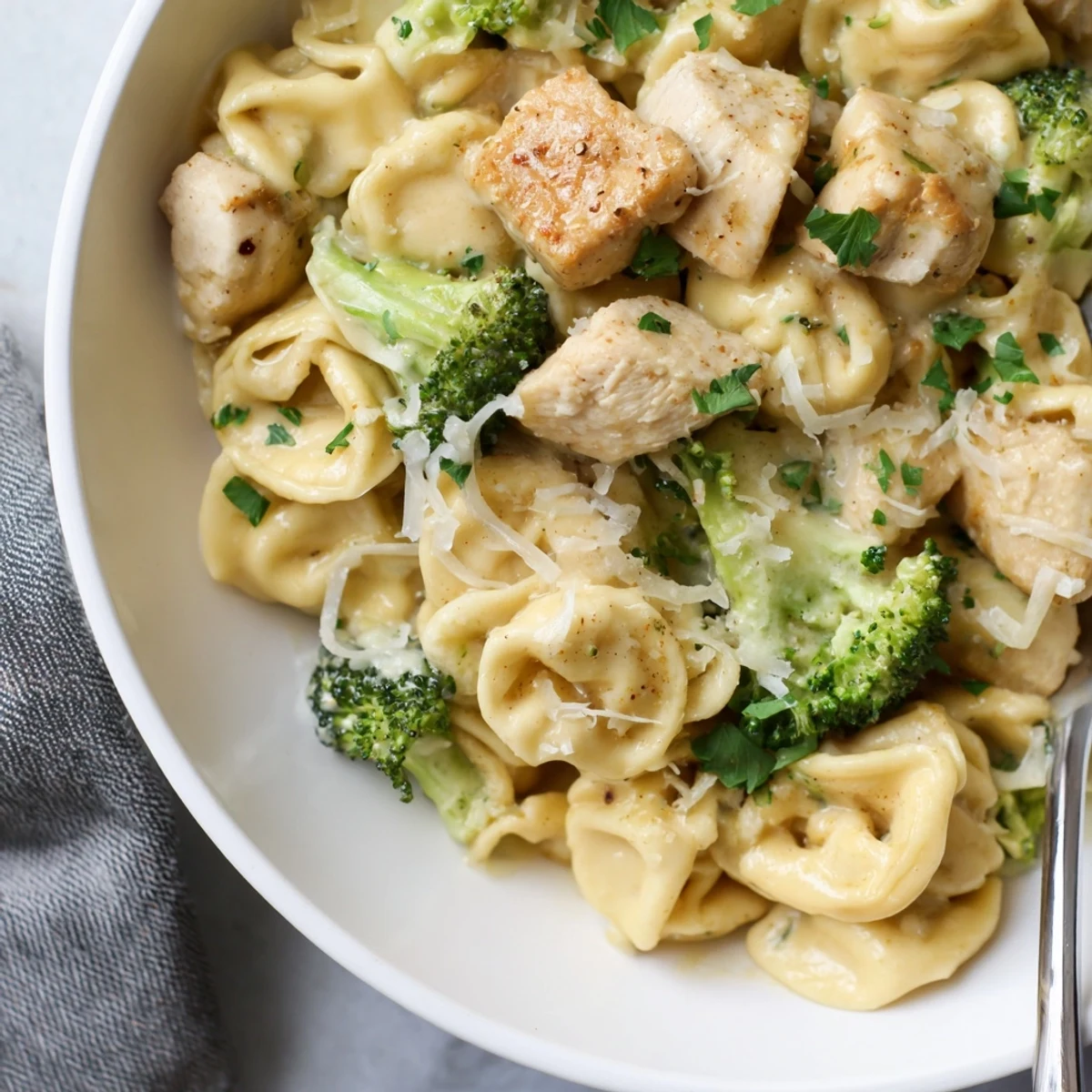 Creamy Garlic Parmesan Tortellini Chicken Broccoli Recipe plated with rich sauce, tender broccoli