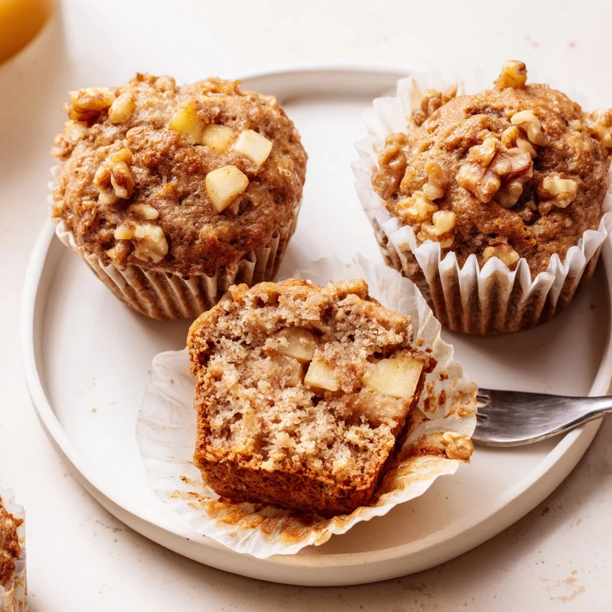 Warm Healthy Apple Cinnamon Greek Yogurt Muffins topped with cinnamon sugar and walnuts