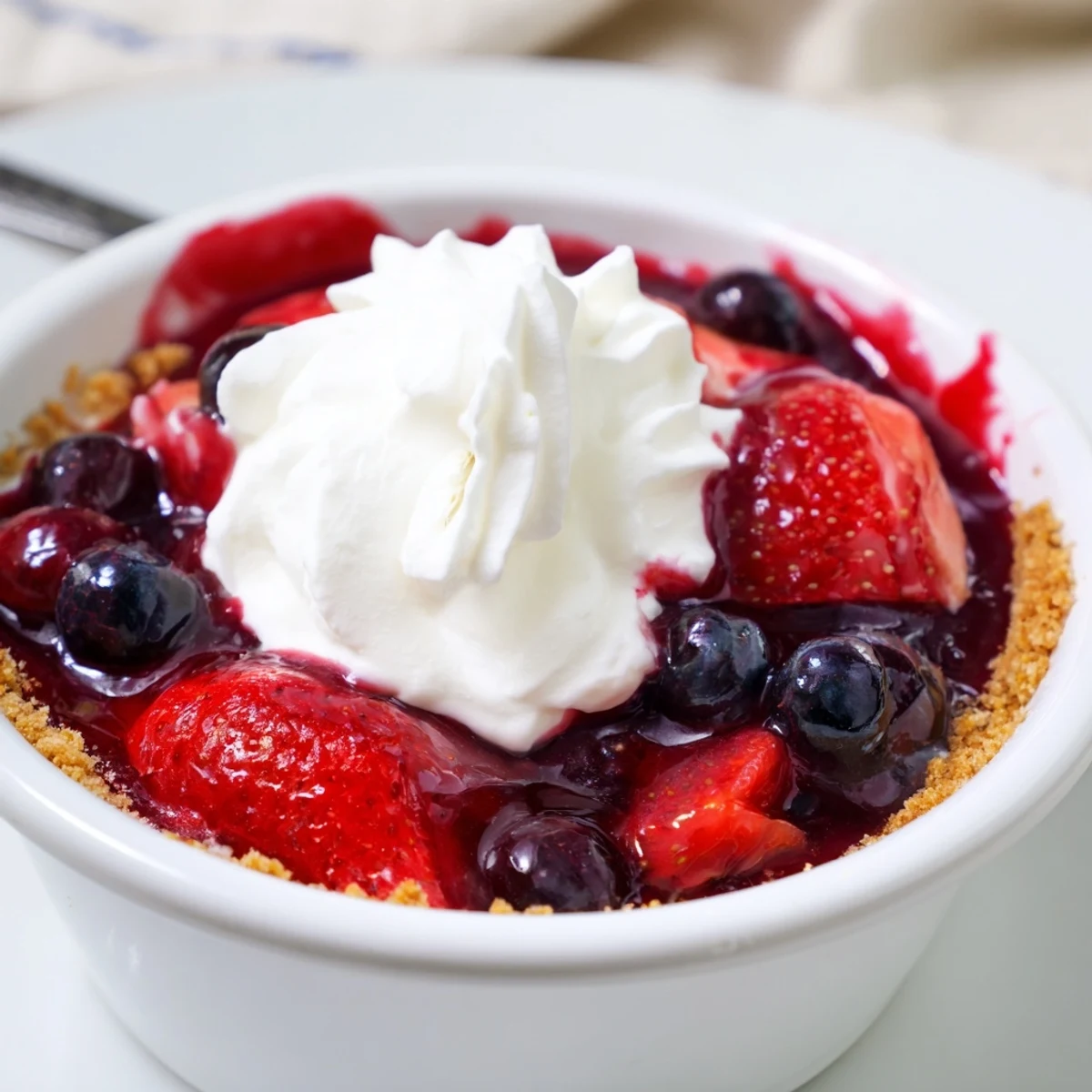 Chilled Berry No Bake Cheesecakes in ramekins, tart berry compote and lemon