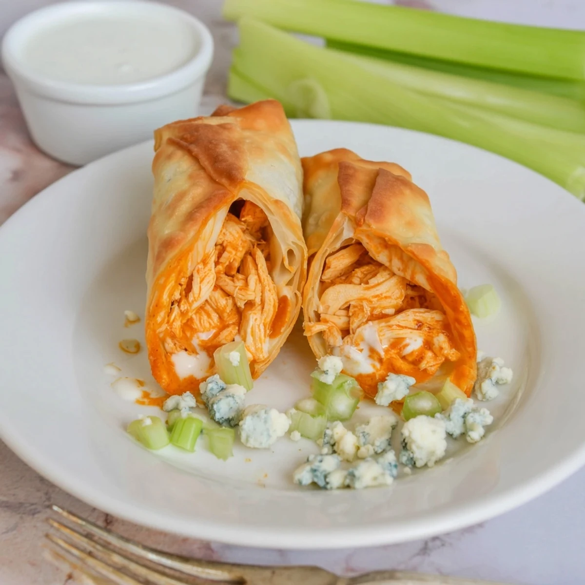 Close-up Buffalo Chicken Egg Rolls Recipe showing spicy filling, crisp golden exterior