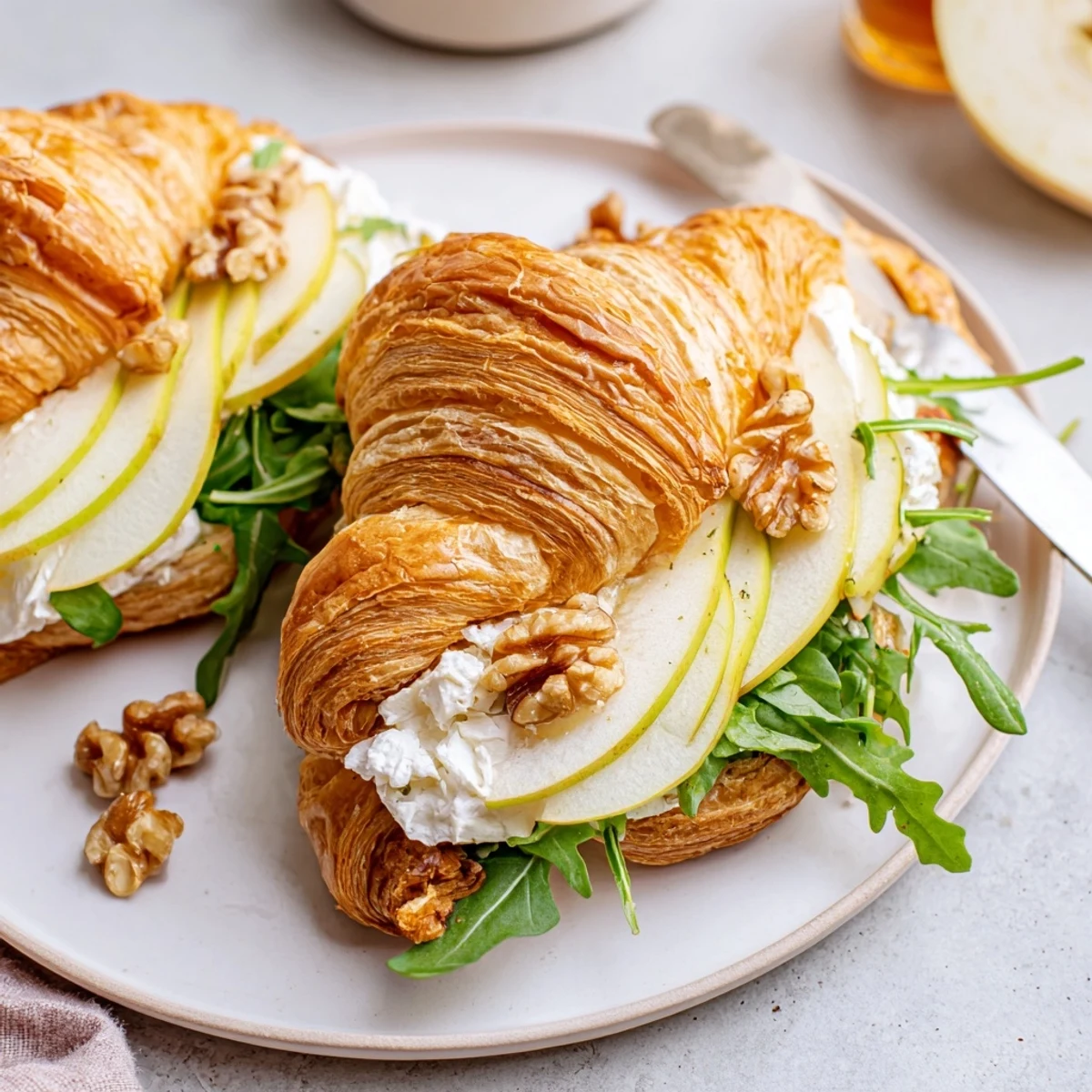 Picnic-ready Apple Goat Cheese Croissant Sandwich with flaky layers, walnut crunch, bright greens