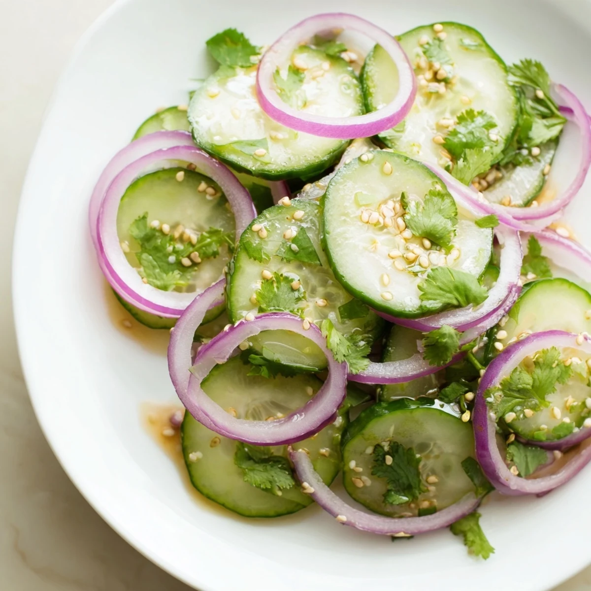 Crisp cucumber slices tossed in tangy honey lime dressing with red onion and sesame seeds
