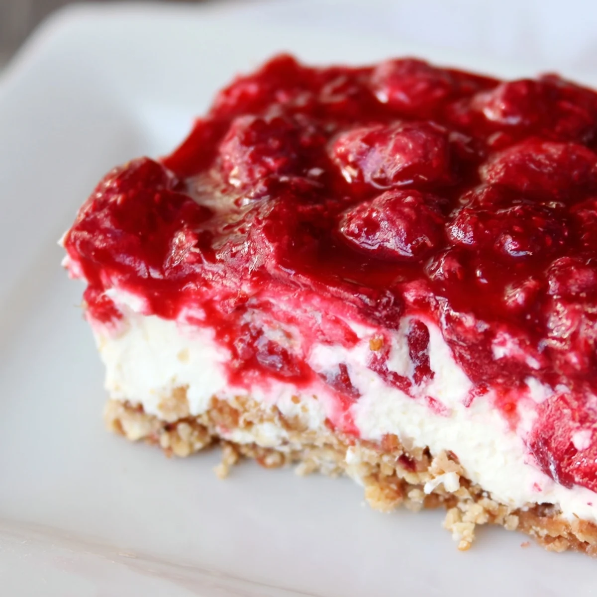 Fresh raspberry no bake dessert featuring silky cream filling and crunchy buttery base