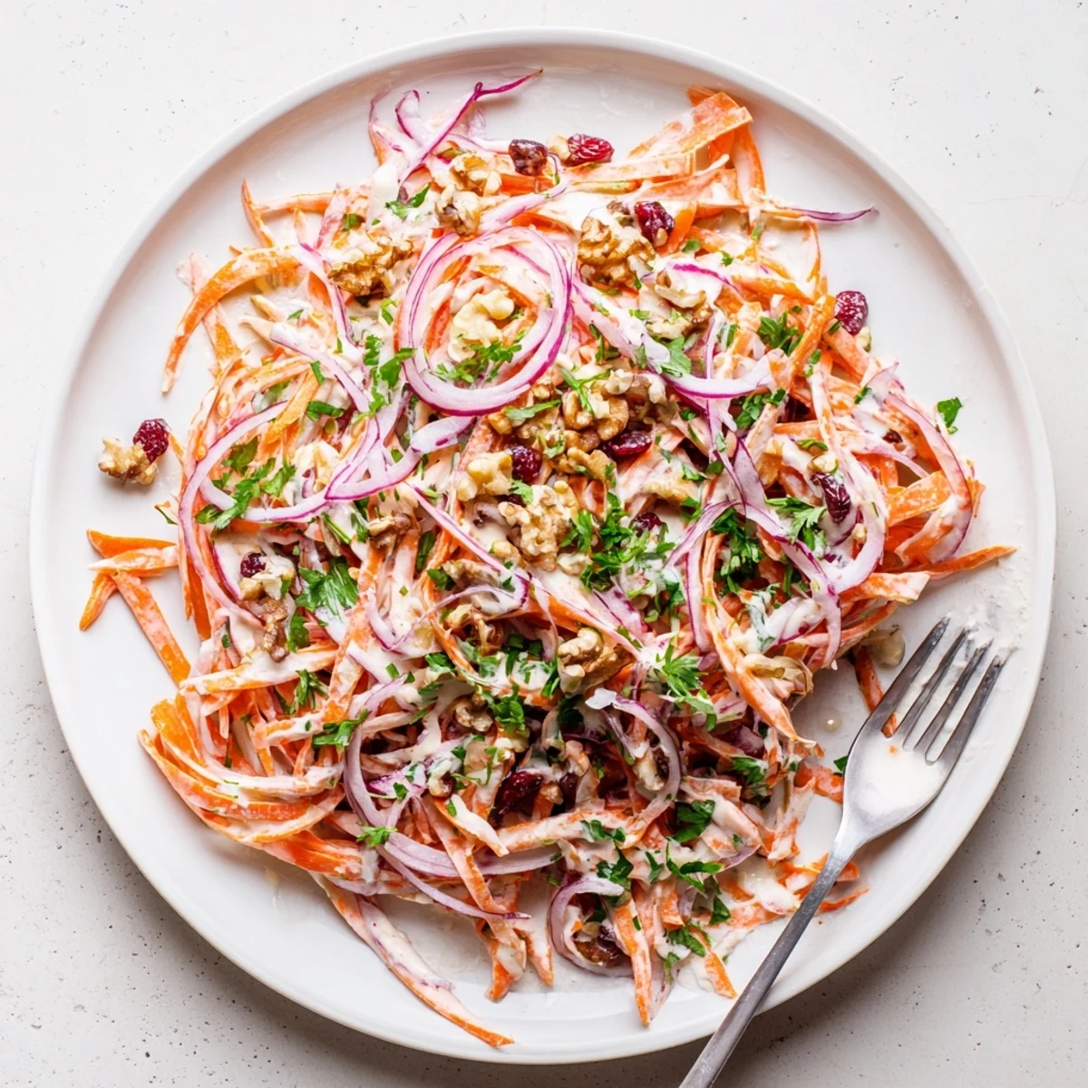 Fresh apple carrot slaw recipe featuring julienned apples and grated carrots in honey mustard dressing