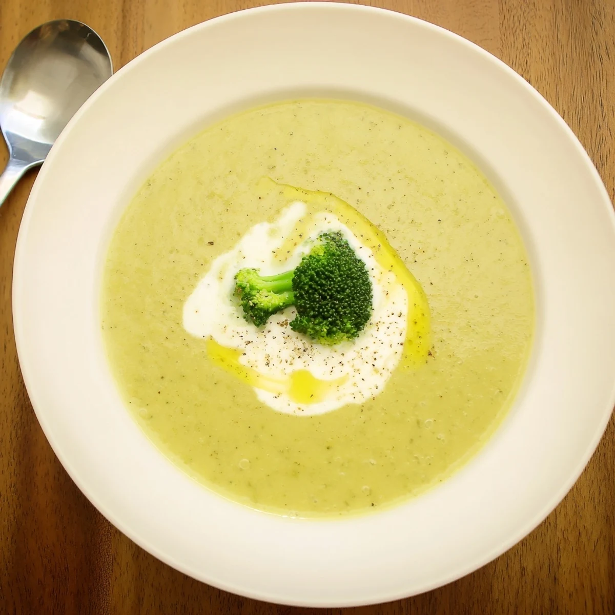 Warm Broccoli Soup with velvety texture, seasoned with nutmeg, crusty bread
