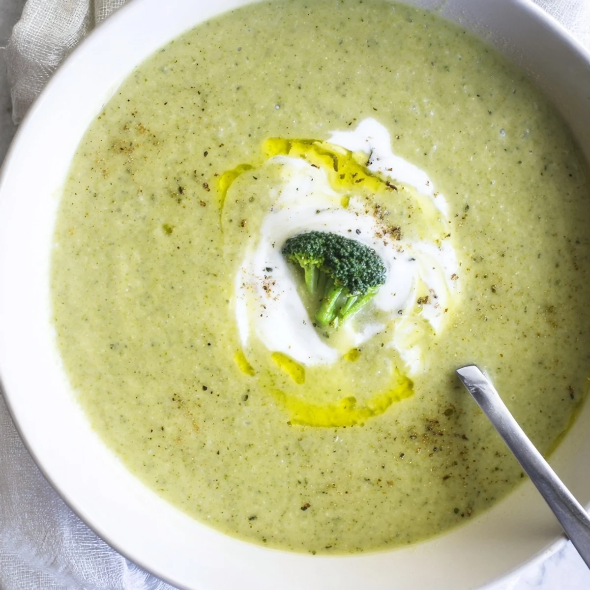 Hearty Broccoli Soup ladled from saucepan, bright green with onion aroma