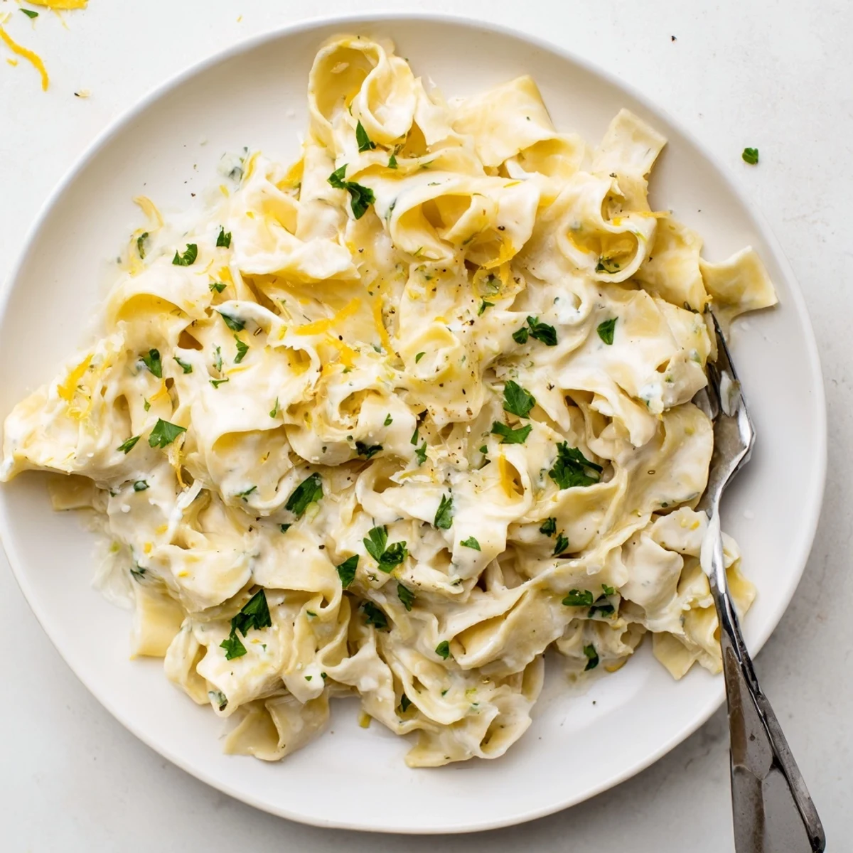 Comforting bowl of cafeteria noodles coated in thick creamy sauce topped with grated Parmesan cheese