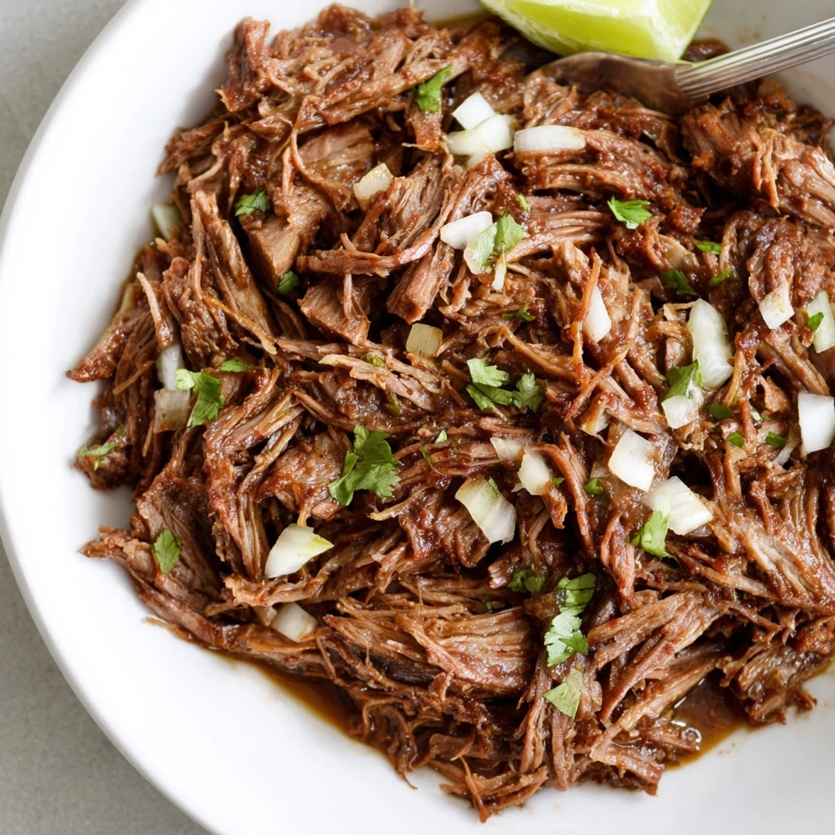 Family-style Slow Cooker Beef Barbacoa shredded, seasoned, ready for tacos or bowls.
