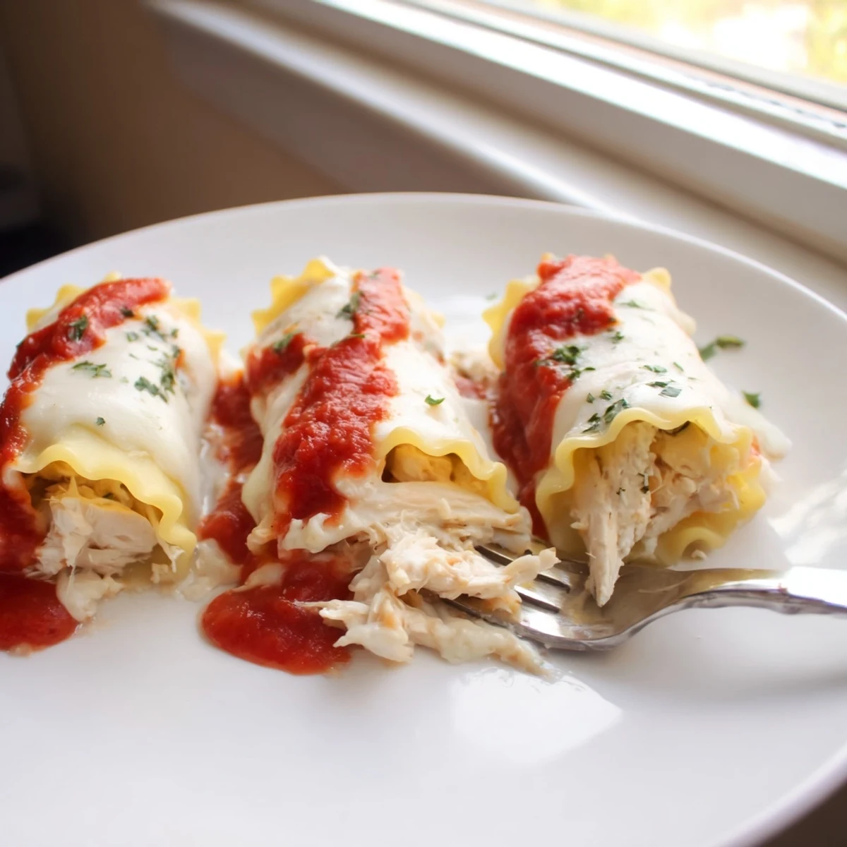 Garlic Parmesan Chicken Lasagna Roll Ups bubbling with melted mozzarella and golden cheese