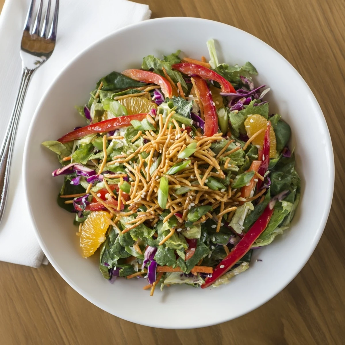 Mandarin Sesame Crunch Salad with bright oranges and golden toasted sesame topping