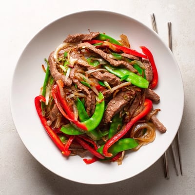 Beef With Oyster Sauce showcases savory aromas and colorful peppers in a quick weeknight dinner.