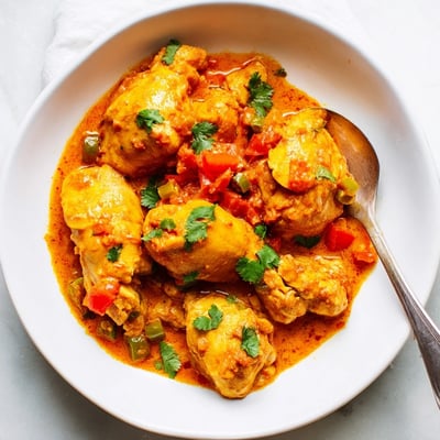 Garnished with fresh cilantro, this Spiced Chicken Curry with Ginger, Garlic & Jalapeño pairs perfectly with fluffy rice.